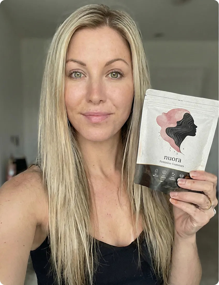 Nuora customer holding a pack of Feminine Balance Gummies